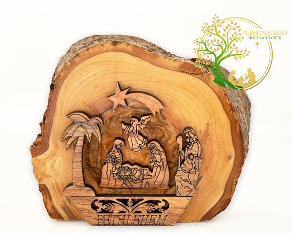 Nativity scene carved on a slice of an olive tree branch. Christmas nativity gift