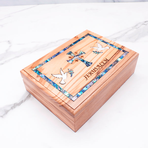 Beautiful olive wood box with mother of pearl cross and doves, engraved with "Jerusalem." Perfect for keepsakes or special gifts!