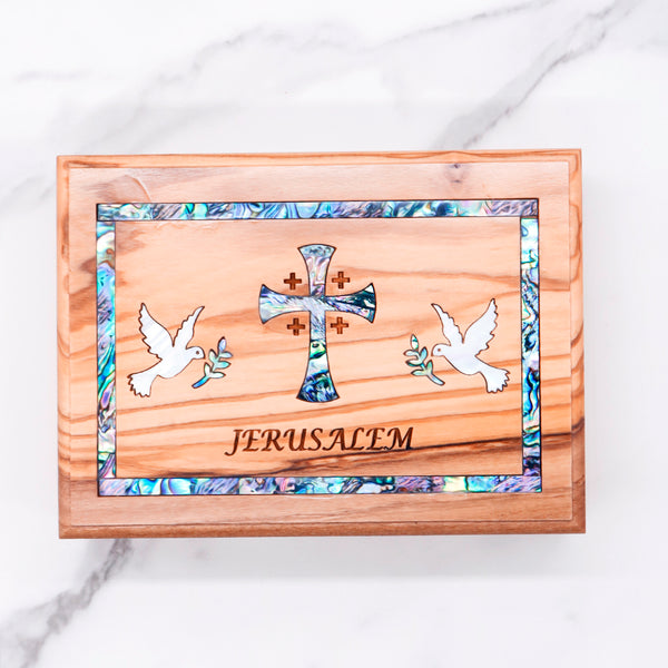 Beautiful olive wood box with mother of pearl cross and doves, engraved with "Jerusalem." Perfect for keepsakes or special gifts!