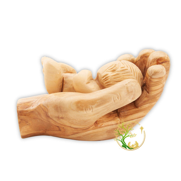 Baby Jesus figurine held in a wooden hand - Baby in Father's hand statue made in the Holy Land