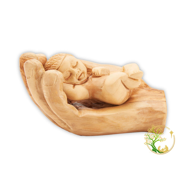 Baby Jesus figurine held in a wooden hand - Baby in Father's hand statue made in the Holy Land